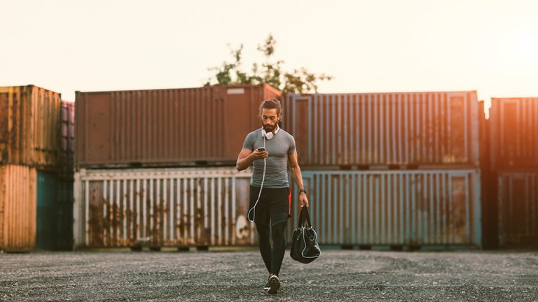 man going to the gym with his gym bag in hand