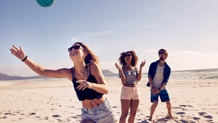 Women playing volleyball on the beach