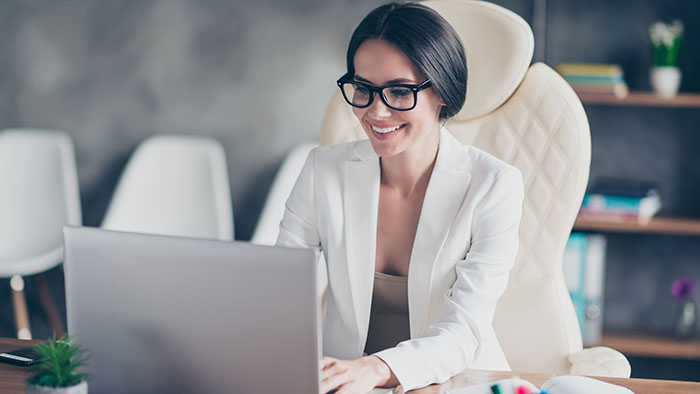 Smiling woman typing on her laptop