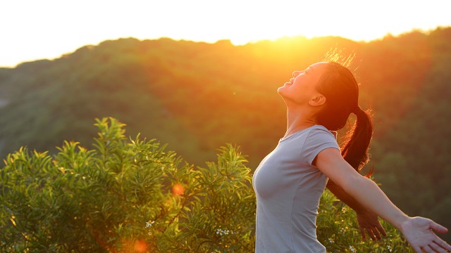 Woman stretching outside in the sun