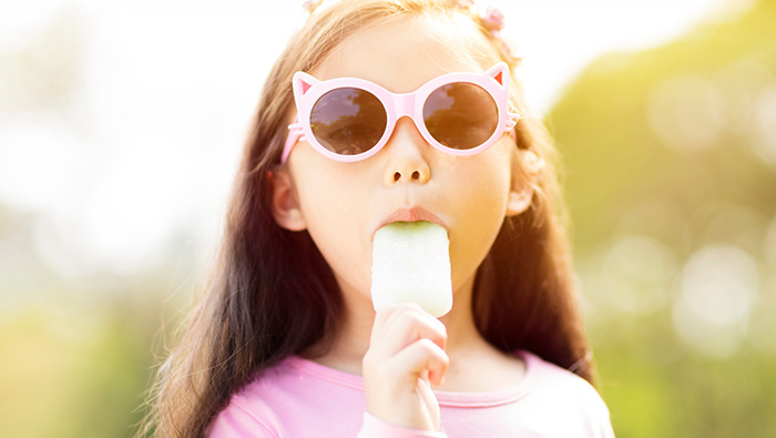 Girl eating popsicle.