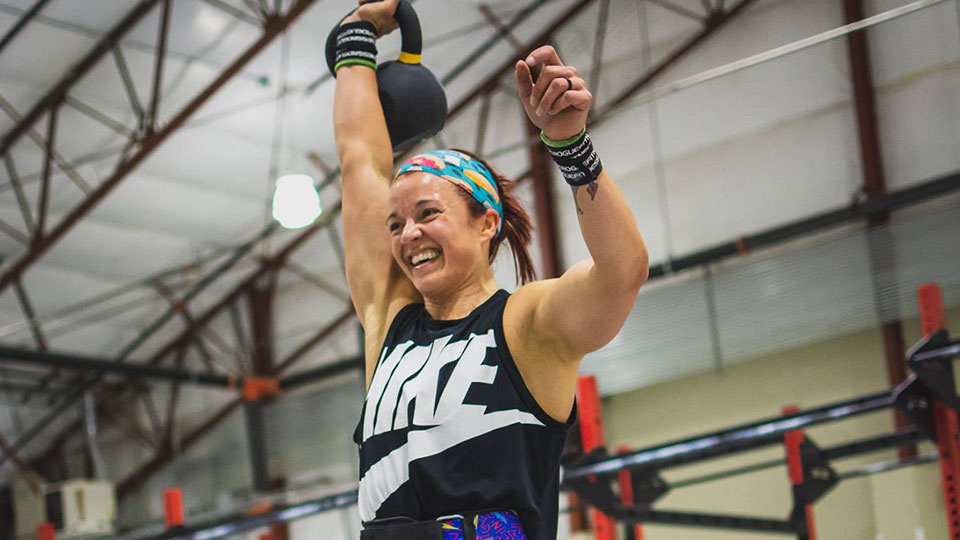 Kayla Johnson smiling while at a fitness competition.