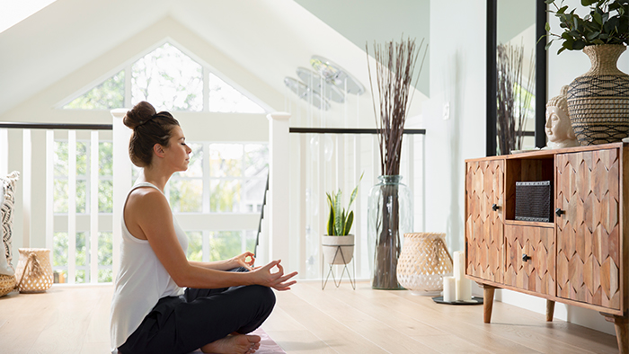 Woman doing yoga in bedroom