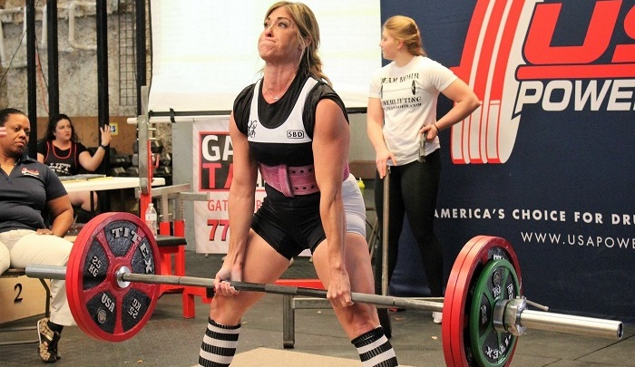 Christie Nix doing a deadlift at a powerlifting competition - healthy changes