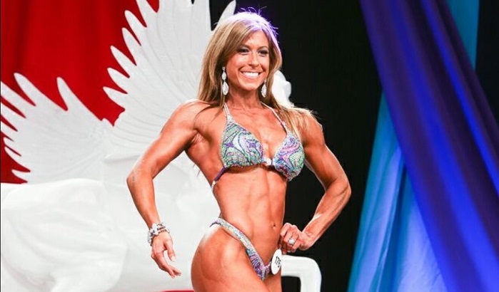 Christie Nix in a bikini posing onstage for a competition - healthy changes