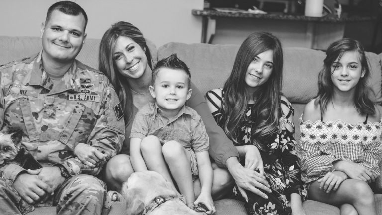 Christie Nix sitting on the couch with her family