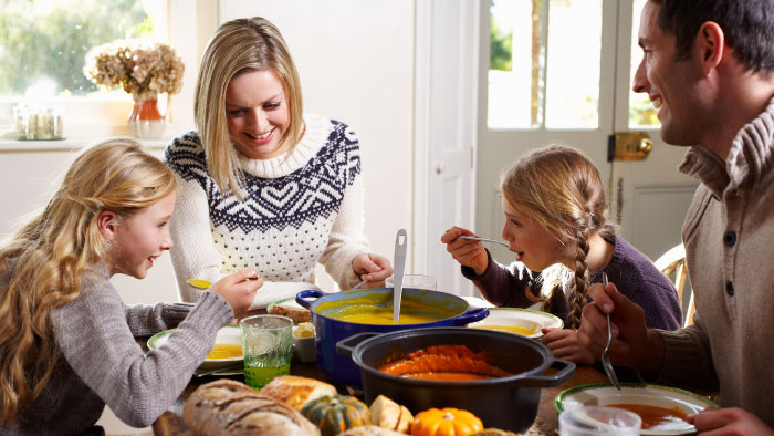 A family enjoysfall foods together at the dinner table