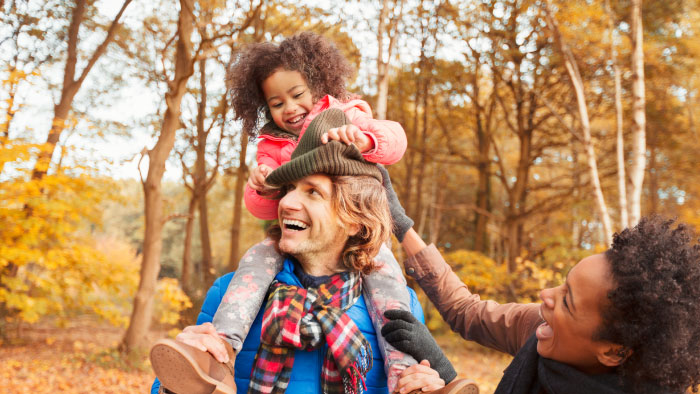 A young girl being carried piggyback during the fall