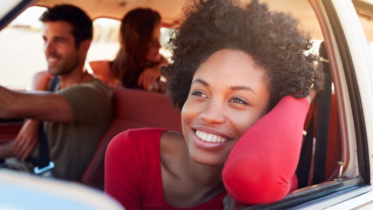 young woman looking out of car window