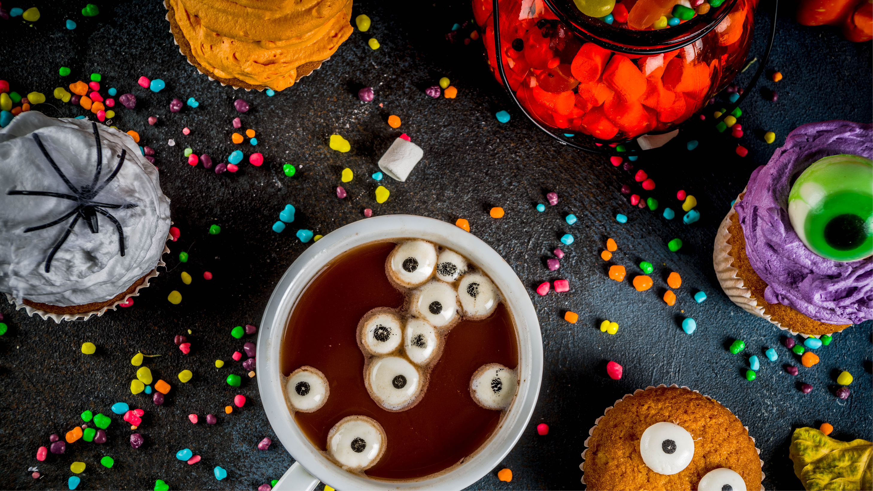 Table with bowls of Halloween candy and sprinkles