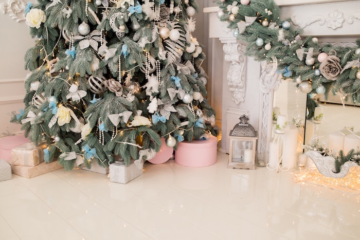 A corner Christmas tree with white and blue decorations