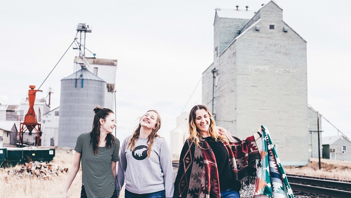 Three women outside in front of a building