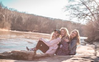 Three friends posing for a picture outside