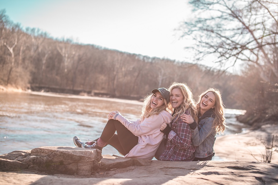 Three friends posing for a picture outside