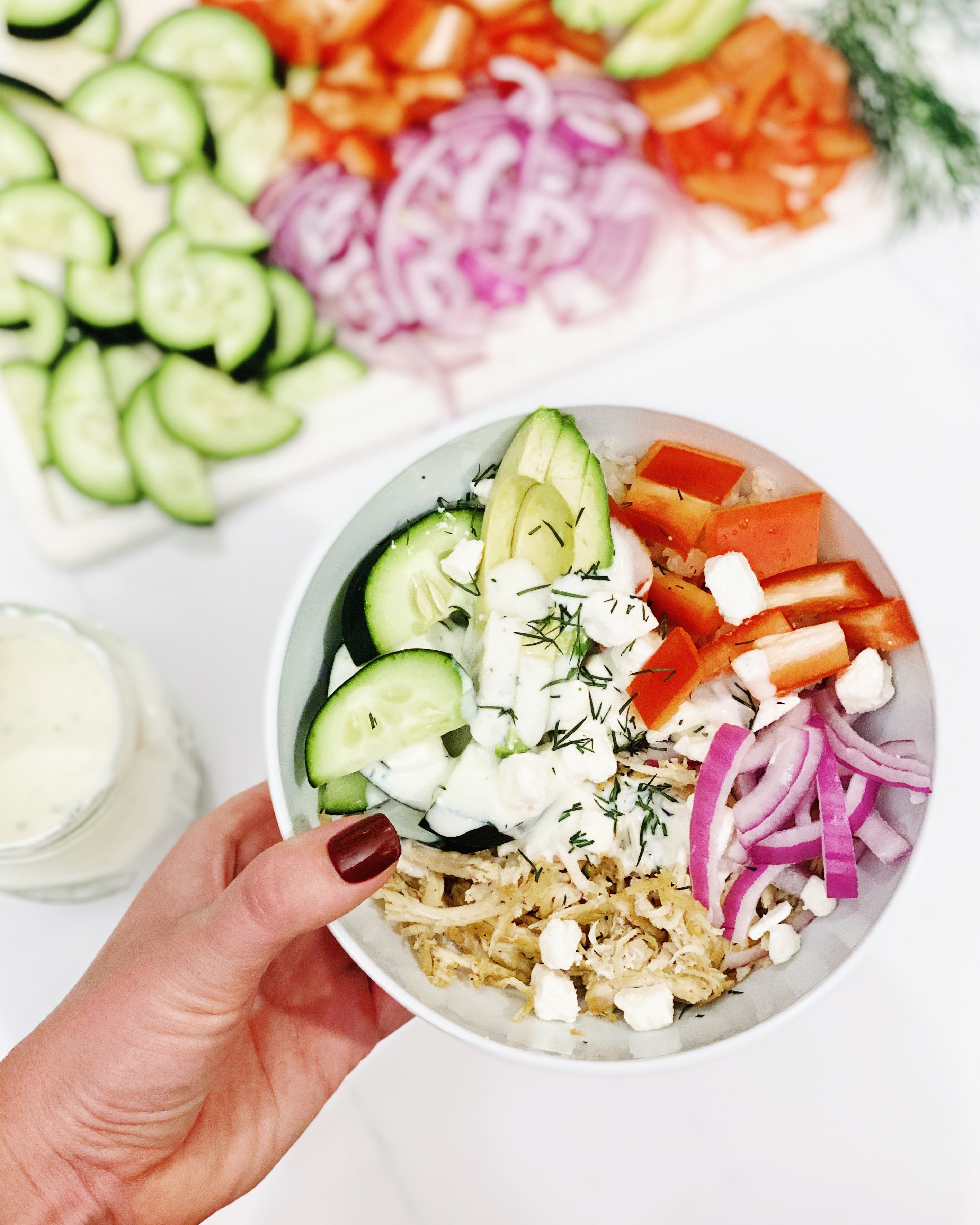 Mediterranean bowl with rice, chicken, and vegetables