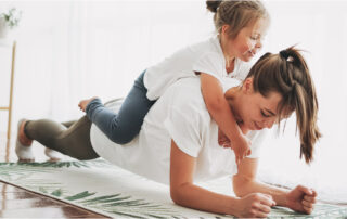 woman planking with kid