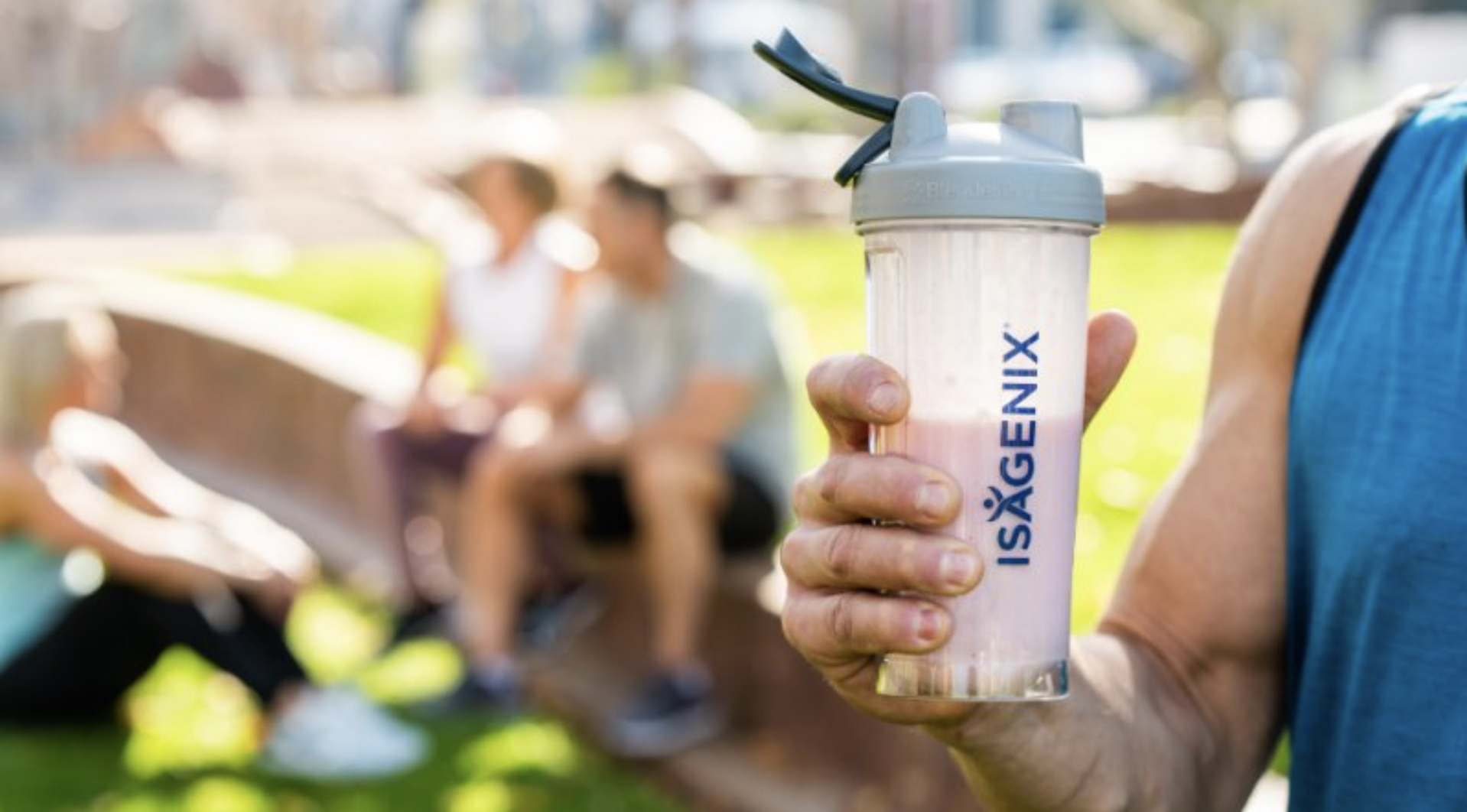 Person holding Isagenix shake outside