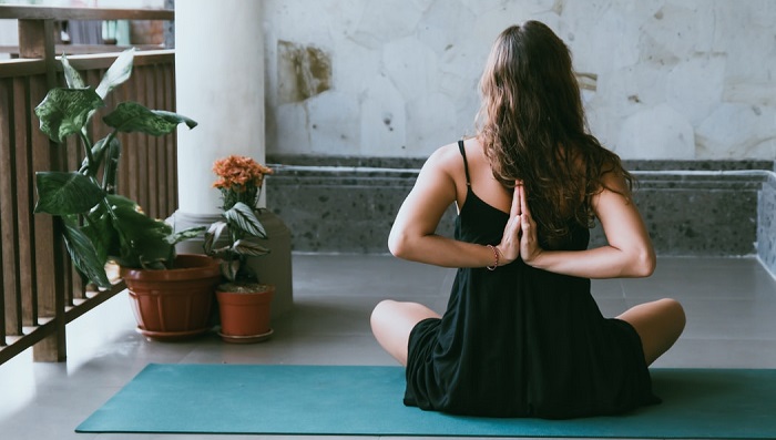 woman does yoga on balcony