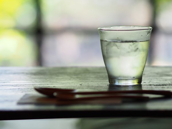 A glass of water on a wood table