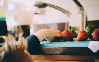 kid and strawberries