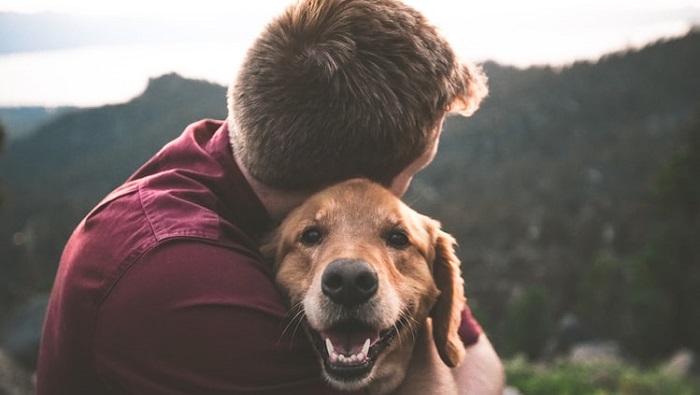 Man hugging dog