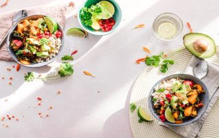 Two healthy protein bowls on a white table