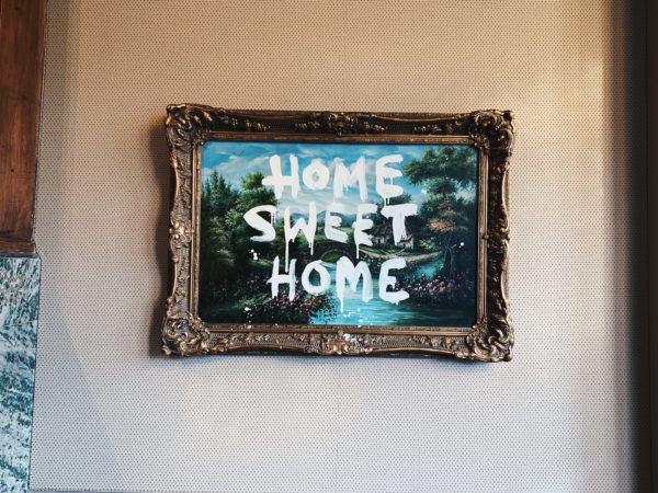 "Home Sweet Home" painting on a wall