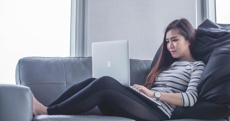 A woman on her laptop on the couch