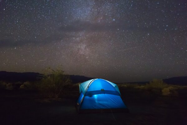 Blue tent under a starry sky