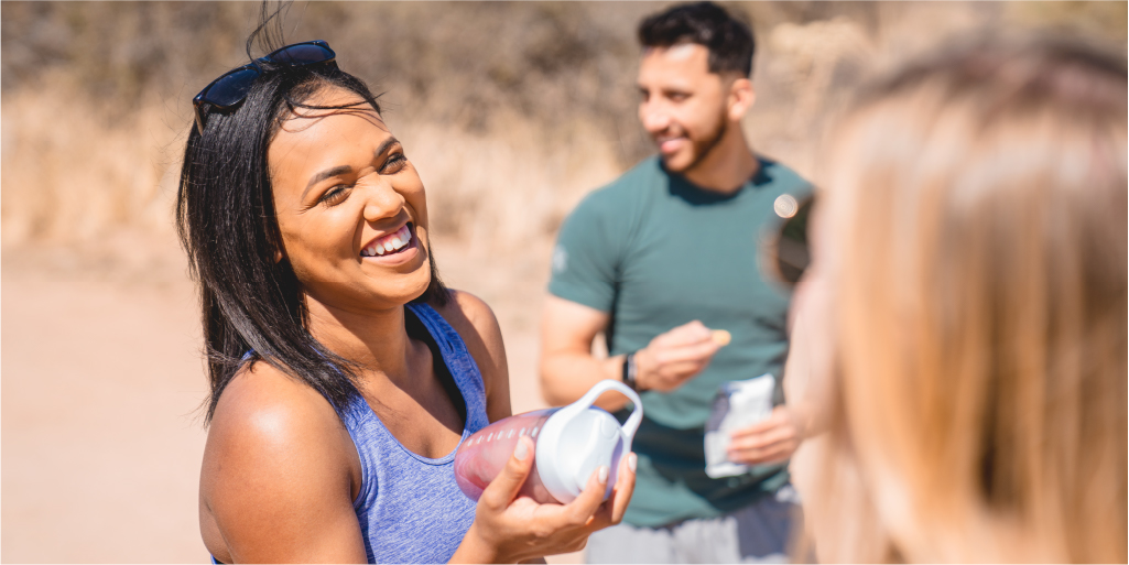 Woman smiling and socializing on a hike