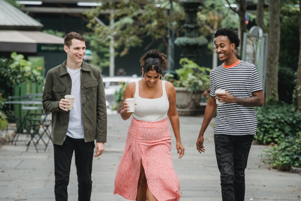 Three young adults socializing on a walk